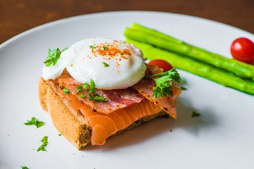 Sandwich with poached egg, parma ham and Salmon