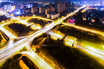 Fototapeta na wymiar Illuminated skyline and overpass in modern city at night