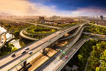 Foto op Aluminium Elevated overpass with skyline of modern city during sunset. © zhu difeng