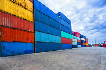 Fototapeta premium stack of containers with empty road in front