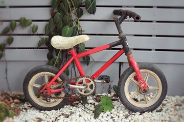 Fototapeta na wymiar Old vintage red children's bicycle.