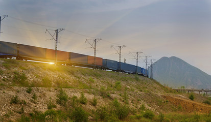 Freight train passing by on sunset