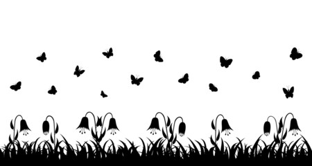 Butterflies over the grass and flowers.