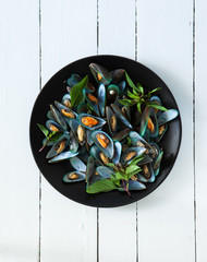 scald mussel with thai sweet basil in black plate