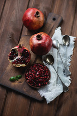 Ripe pomegranates over rustic wooden surface, high angle view