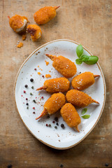 Plate with roasted breaded crab claws, view from above