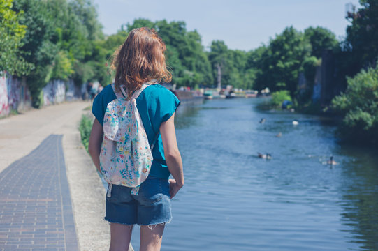 Young woman standing by canal