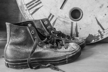Obraz na płótnie Canvas Sneakers and a clock with black and white.
