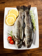 Fresh raw trout on wooden background 