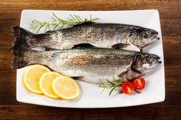 Fresh raw trout on wooden background 