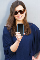 Cheerful woman talking photo on the phone in the street casual o