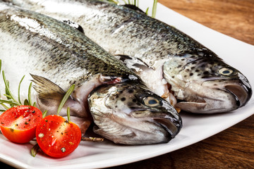 Fresh raw trout on wooden background 