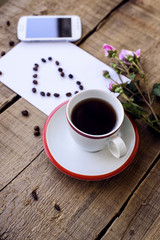 coffee cup, sheet of paper with heart, roses and mobile phone
