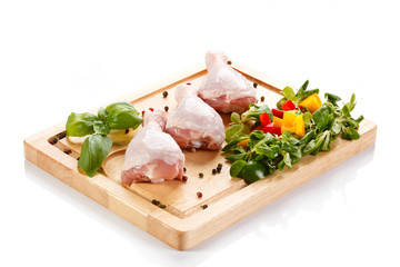 Raw chicken legs on cutting board 