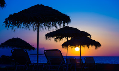 Parasol at the beach at sunset