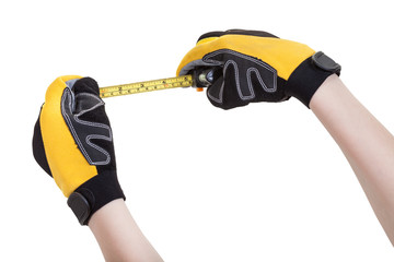 builder hands in safety glowes with measuring tape