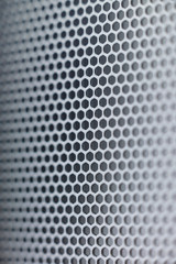 Grid of Acoustic column. Grey background. Macro.