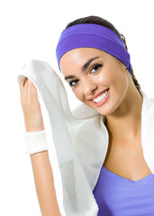 brunette woman in violet fitness wear with towel, isolated