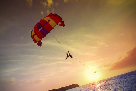 Paragliders at sunset, summer adventure in Malaysia.