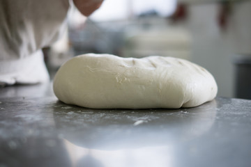 Baker Steping up to  Fresh Bread Dough