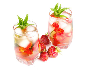 strawberries in bulk on a white background, a glass with a drink