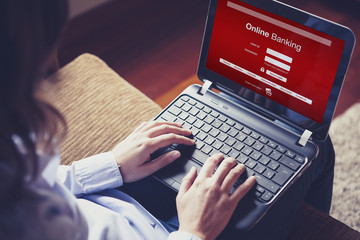 Female getting access into On line banking. Typing on keyboard.