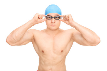 Young male swimmer with a swim cap and goggles