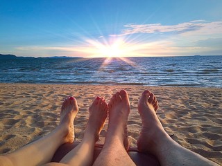 couple feet chill on beach  