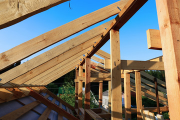 Installation of wooden beams at construction of the frame house