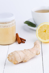 Fresh ginger and mint tea on wooden table.