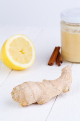 Fresh ginger and lemon on wooden table.