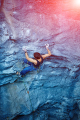 Rock climber climbing up a cliff © vitaliymateha