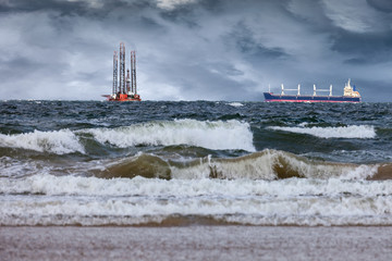 Oil Rig with ship at sea during a storm.