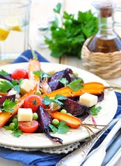salad from roasted carrots and beets in olive oil, with cheese