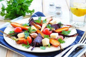salad from roasted carrots and beets in olive oil, with cheese