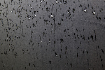 pattern of rain drops on black surface