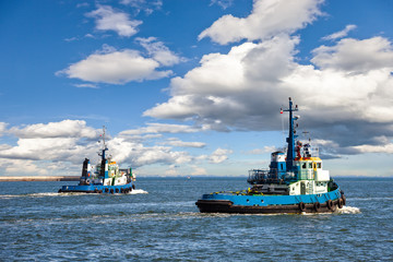 Two Tugs Heading out to Sea in Gdynia, Poland.