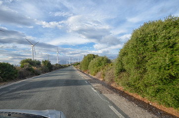 Fototapeta na wymiar Wind turbines from the car