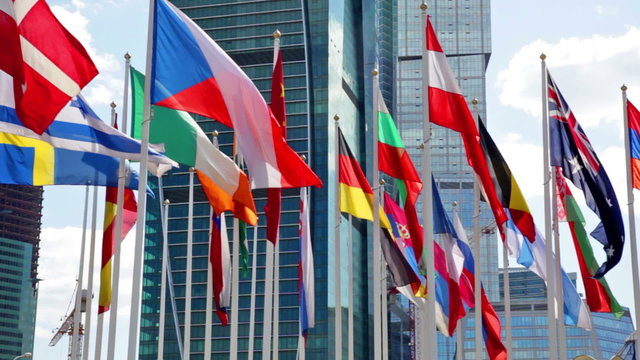 Flags of the different countries of the world against the business center