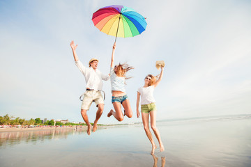 Group of happy young people having fun on the beach
