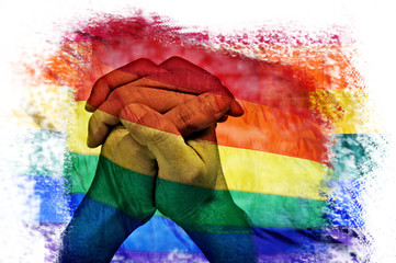 multiple exposures of the rainbow flag and the clasped hands of