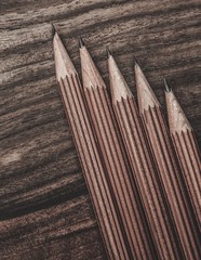Luxurious charcoal drawing pencils on a wooden table