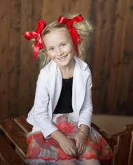 Smiling girl with bright red bows