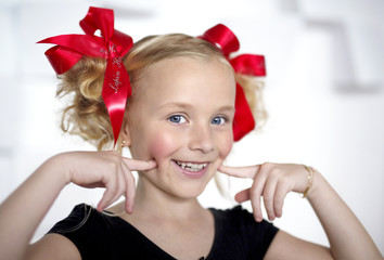 Smiling girl shows dimples on the cheeks