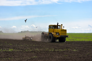 Fototapeta premium Tractor plowing a field