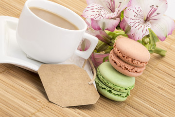 macaroons and coffee on table with name tag