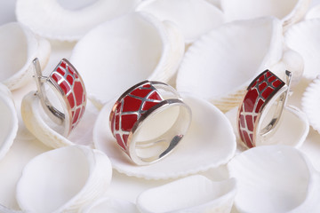 Beautiful gold ring and earrings with enamel on white seashells.