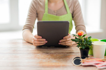 close up of woman or gardener holding tablet pc