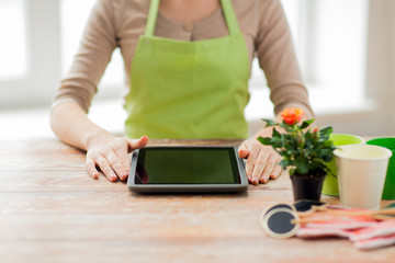 close up of woman or gardener with tablet pc