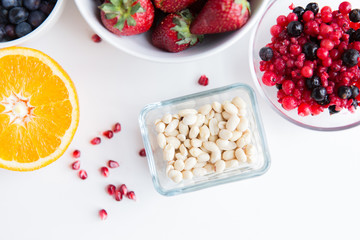 close up of fruits and berries in bowls on table